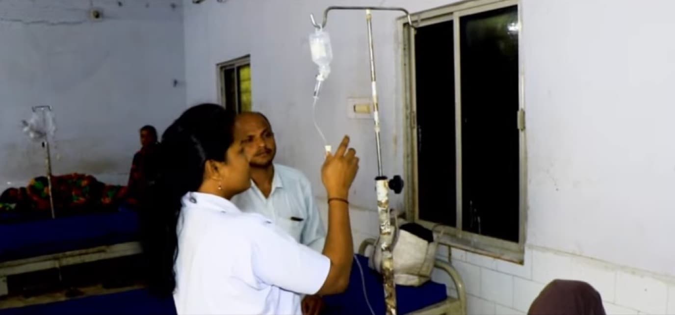 Nurse administering IV drip